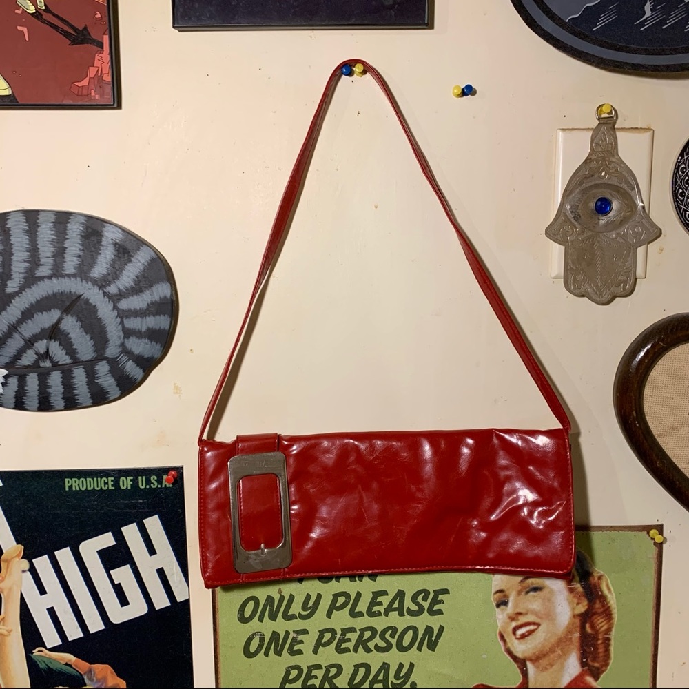 Blood red shoulder bag with oversized sized buckle